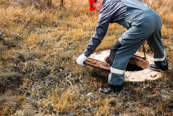 Technician performing septic system inspection